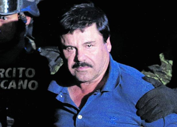 FILE PHOTO: Recaptured drug lord Joaquin "El Chapo" Guzman is escorted by soldiers at the hangar belonging to the office of the Attorney General in Mexico City