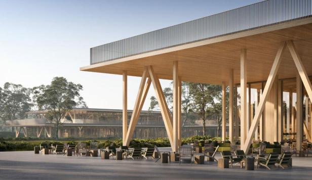 Das Café eines modernen Holzgebäudes mit Sitzgelegenheiten im Freien.