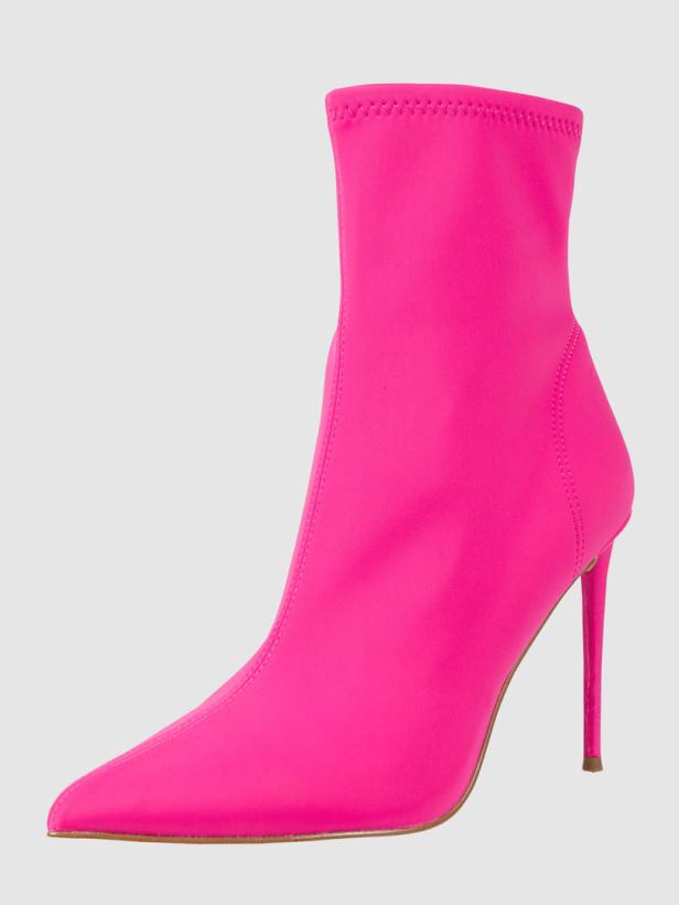 Ein pinkfarbener Stiefel mit hohem Absatz vor einem neutralen Hintergrund.