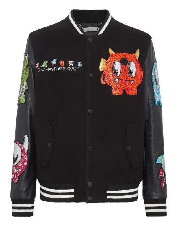 Eine schwarze Collegejacke mit bunten Monster-Applikationen und dem Schriftzug „Lil Monster$ Gang“.