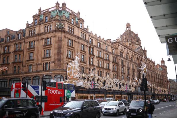 Vehicles drive past the Harrods department store, owned by the Qatar Investment Authority, in London