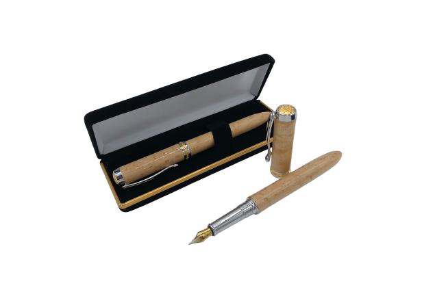 Ein Füllfederhalter aus hellem Holz liegt in einer schwarzen Schatulle, daneben ein zweiter Stift.