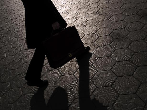 Shadow of Businessman walking with briefcase