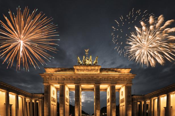 Das Brandenburger Tor in Berlin wird von Feuerwerk erhellt.