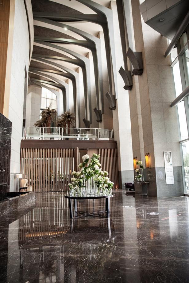 Ein Blumenarrangement steht im Foyer eines modernen Gebäudes.