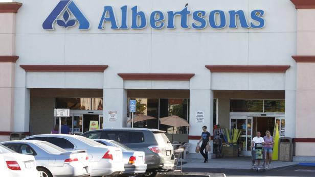 Customers leave an Albertsons grocery store with t