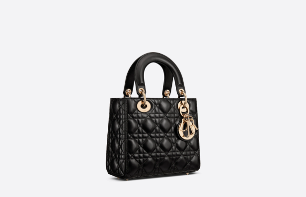 Eine schwarze „Lady Dior“ Handtasche mit goldenen Akzenten.
