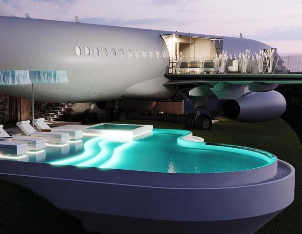 Ein Flugzeugrumpf dient als luxuriöses Haus mit Pool und Terrasse.