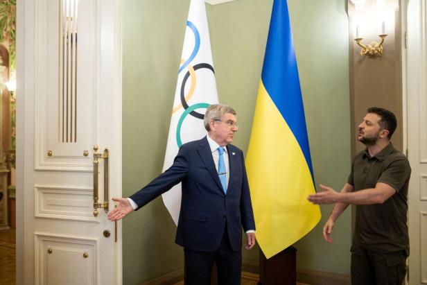Ukrainian President Zelenskiy and IOC President Bach gesture before a meeting in Kyiv