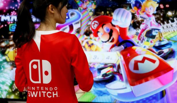 FILE PHOTO: An event employee of Nintendo attends the presentation ceremony of its game console Switch in Tokyo