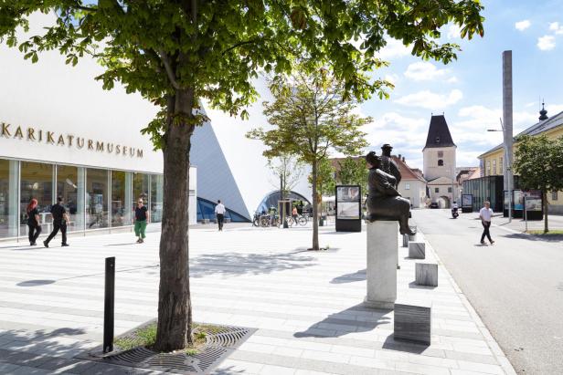 Das Karikaturmuseum in Krems an der Kunstmeile mit einer Skulptur im Vordergrund.