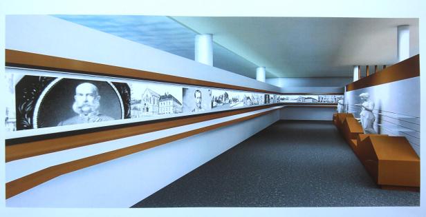 Ein Innenraum mit einer Reihe von Schwarz-Weiß-Porträts und Statuen.