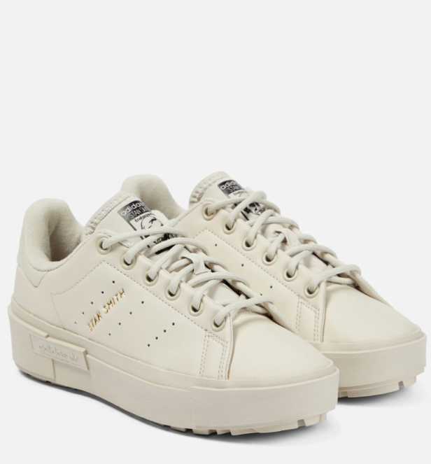 Zwei cremefarbene Adidas Stan Smith Sneaker mit Plateausohle stehen vor einem weißen Hintergrund.
