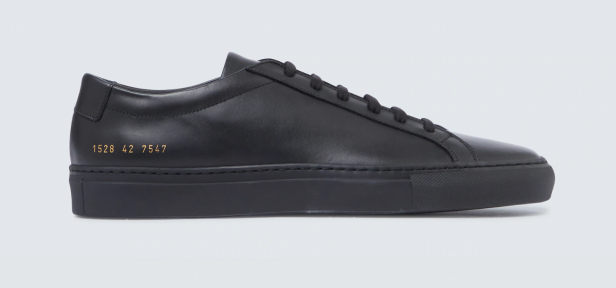 Ein schwarzer Ledersneaker mit goldenen Ziffern an der Seite.