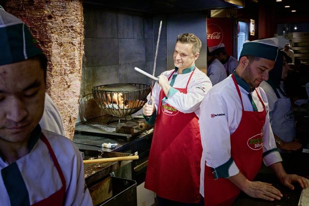 Köche bereiten Dönerfleisch in einem Restaurant zu.