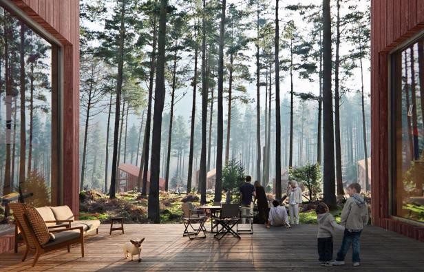 Eine Gruppe von Menschen und ein Hund auf einer Holzterrasse vor einem Wald.