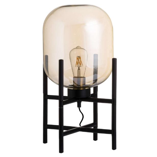 Eine Tischlampe mit einem bernsteinfarbenen Glasschirm und einem schwarzen Metallfuß.