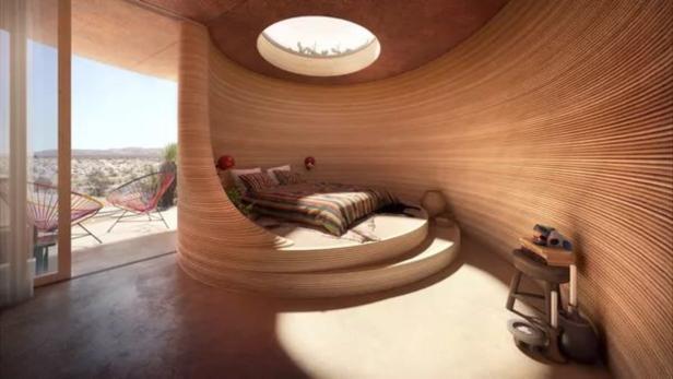 Ein Schlafzimmer mit einem runden Bett und Blick auf die Wüste.