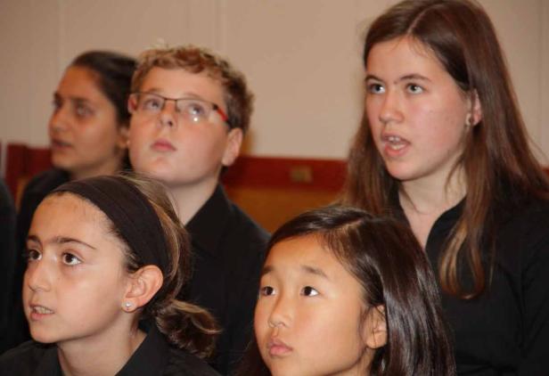 Eine Gruppe von Kindern singt gemeinsam in einem Chor.