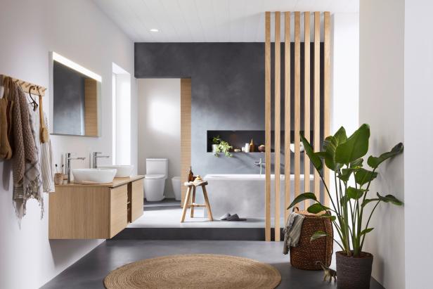 Ein modernes Badezimmer mit Doppelwaschbecken, Badewanne und Holzelementen.