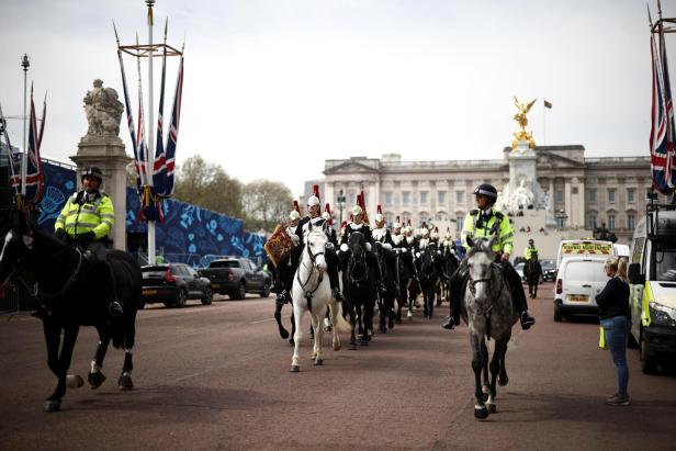 People gather outside Buckingham Palace ahead of the Coronation, in London