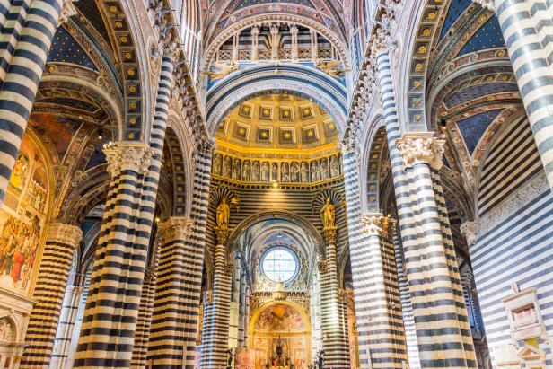 Innenansicht des Doms von Siena mit seinen markanten schwarz-weiß gestreiften Säulen.