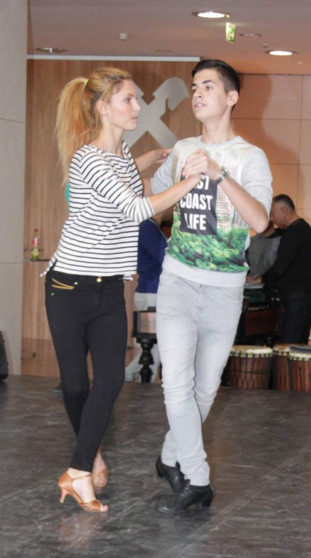 Ein junges Paar tanzt zusammen in einem Raum.