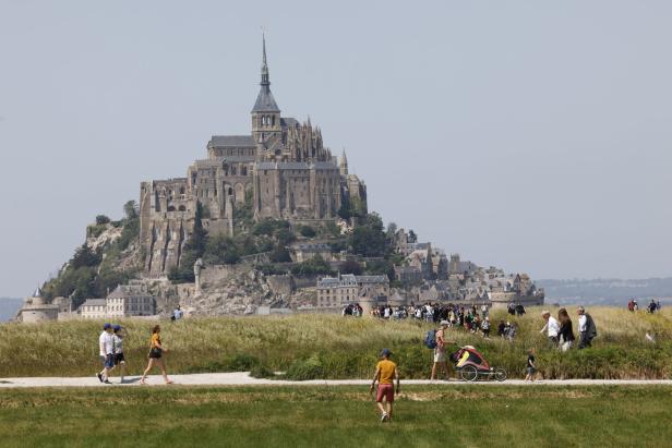 Menschen besuchen den Mont-Saint-Michel in der Normandie.