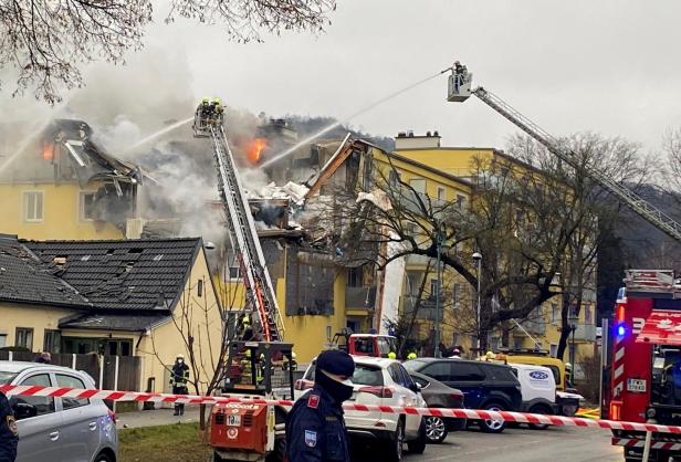 Rescue workers are seen at the site of an explosion of a house in Langenzersdorf