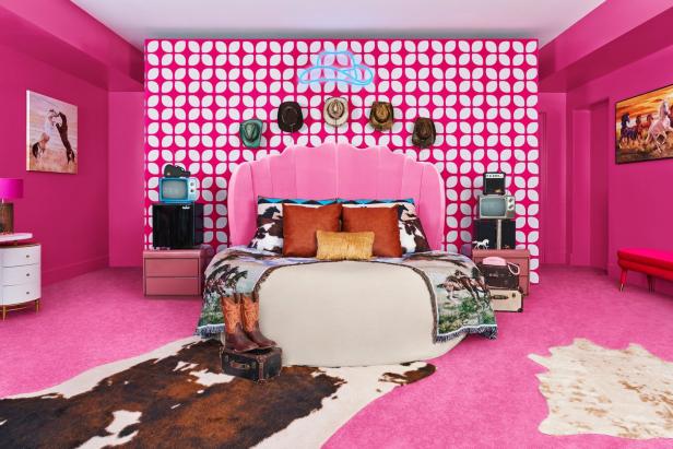 Ein pinkfarbenes Schlafzimmer mit Cowboy-Dekor, inklusive Stiefel, Hüte und Kuhfellteppich.