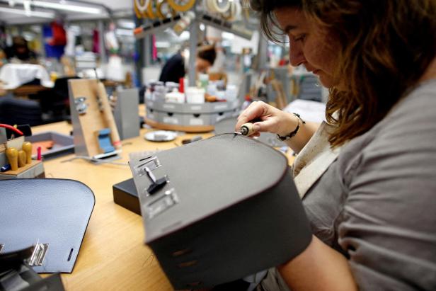 FILE PHOTO: A craftswoman works on a Birkin bag at the luxury goods Hermes factory in Seloncourt