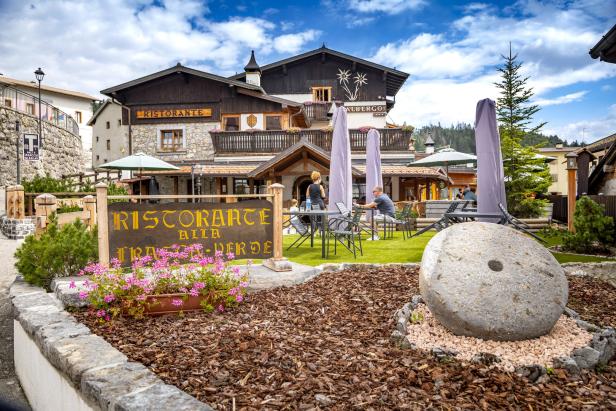 Einladende Außenansicht des „Ristorante Alla Frasca Verde“ mit Gästen auf der Terrasse.