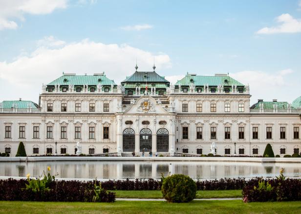 Das Schloss Belvedere in Wien spiegelt sich im Wasser.