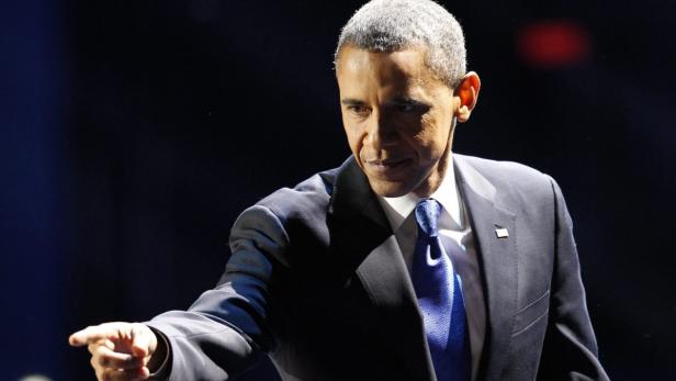 Barack Obama in Anzug und Krawatte deutet mit dem Finger.