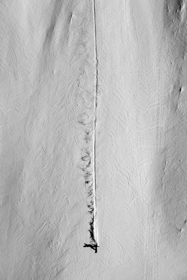 Ein Skifahrer hinterlässt eine Spur im unberührten Schnee.