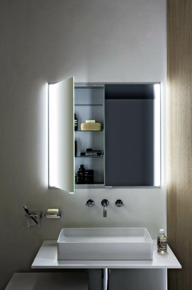 Ein Badezimmer mit einem Waschbecken und einem beleuchteten Spiegelschrank.