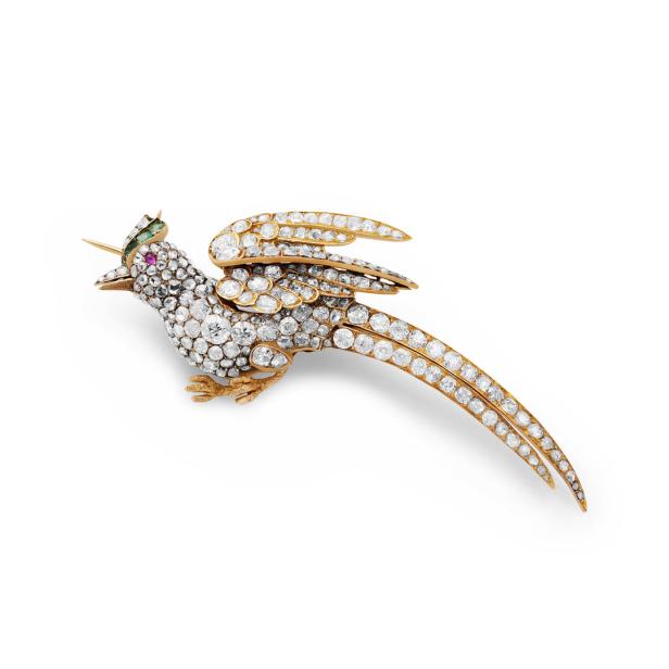 Eine goldene Vogelbrosche, besetzt mit Diamanten, Rubin und Smaragd.