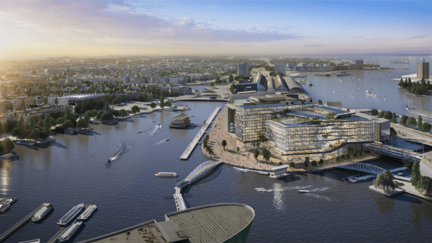Eine Luftaufnahme des Booking.com Campus in Amsterdam am Wasser.