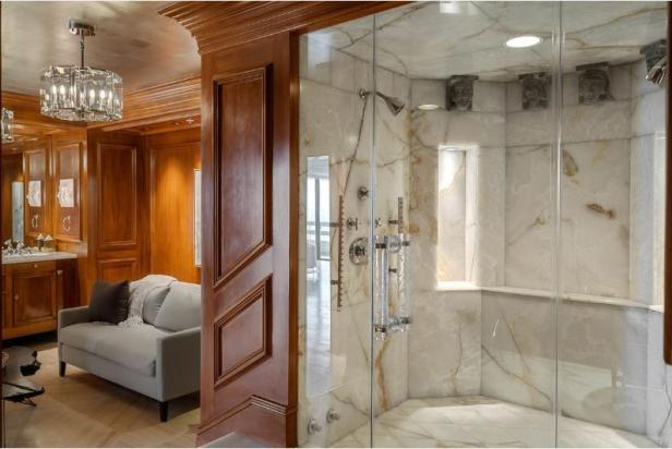 Ein luxuriöses Badezimmer mit einer begehbaren Dusche und einem angrenzenden Wohnbereich.