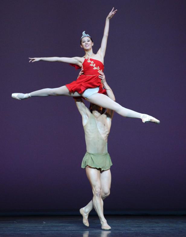 Ein Ballett-Tanzpaar führt eine Hebefigur auf der Bühne auf.