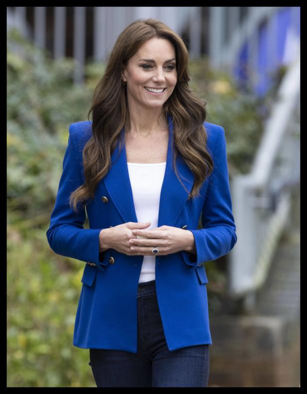 Catherine, Prinzessin von Wales, lächelt in einem blauen Blazer.