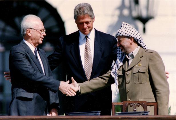FILE PHOTO: PLO Chairman Arafat shakes hands with Israeli PM Rabin after the signing of the Israeli-PLO peace accord, in Washington