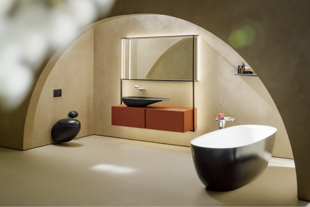 Ein modernes Badezimmer mit freistehender Badewanne, Waschtisch und Toilette in einem gewölbeartigen Raum.