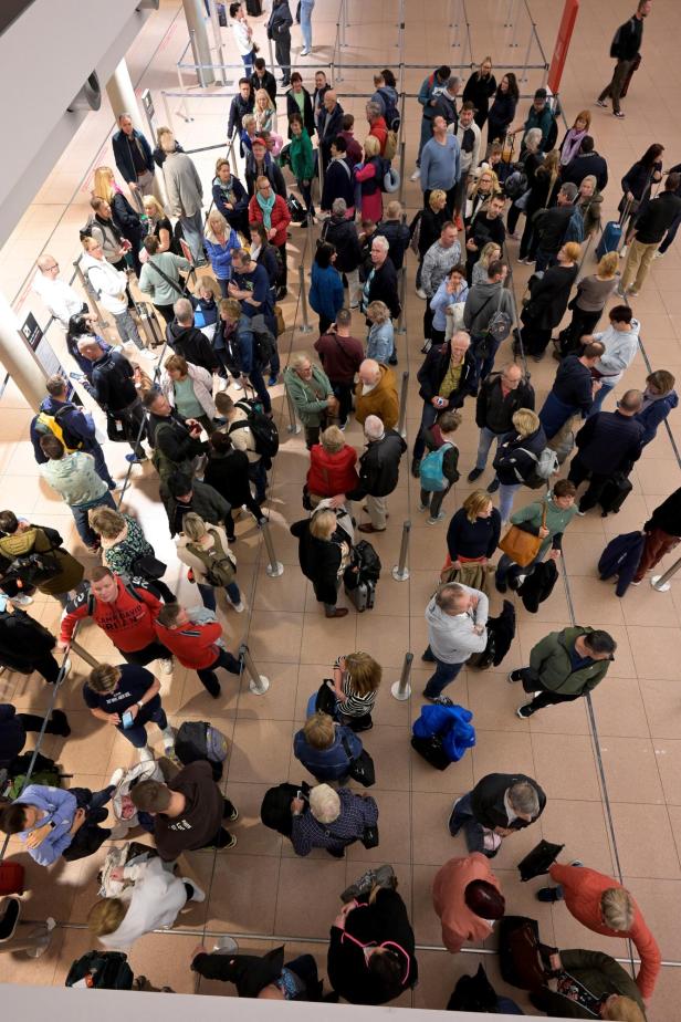Passengers wait at the reopened terminal of Hamburg Airport following a security incident, in Hamburg Passengers wait at the reopened terminal of Hamburg Airport following a security incident, in Hamburg