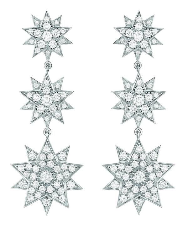 Zwei silberne Ohrringe in Sternform, besetzt mit zahlreichen Diamanten.
