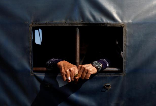 Nepal police personnel detains people from an area where Pro-monarchist protesters had declared to gather for a protest demanding the restoration of Nepal's monarchy in Kathmandu