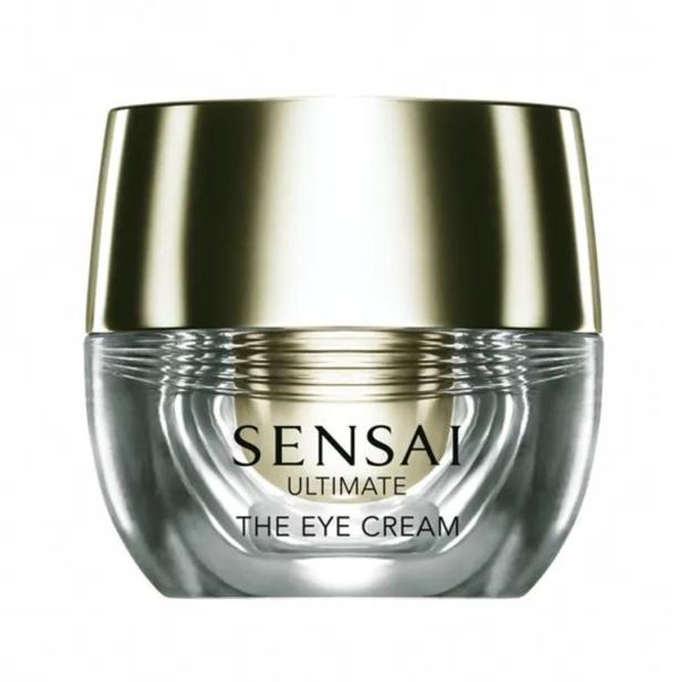 Ein Tiegel „Sensai Ultimate The Eye Cream“ mit goldenem Deckel steht vor einem weißen Hintergrund.