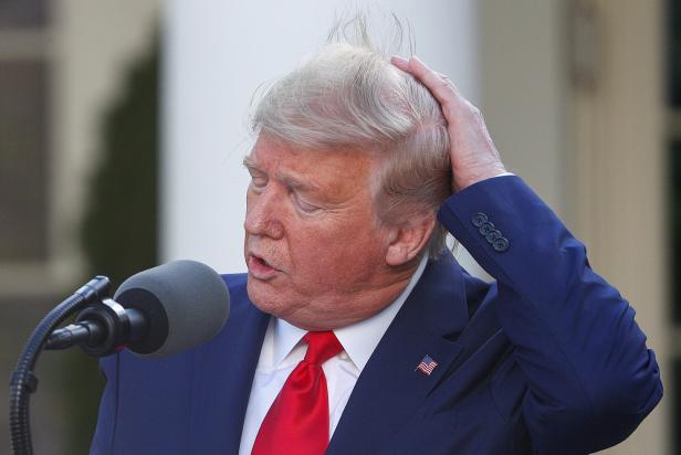 Donald Trump spricht am Mikrofon und fährt sich mit der Hand durch die Haare.