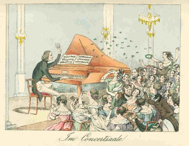 Ein Pianist spielt vor einem begeisterten Publikum in einem Konzertsaal.