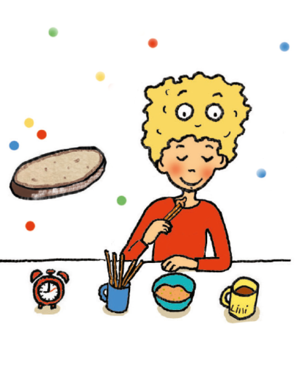 Ein Junge isst Brotstangen mit Dip am Tisch.